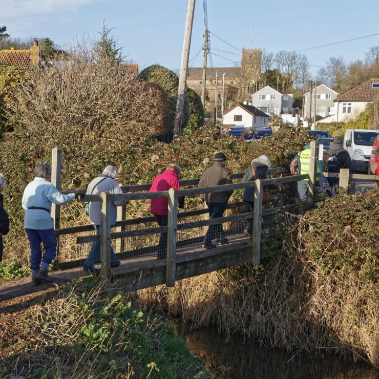 Walkers crosssing a bridge