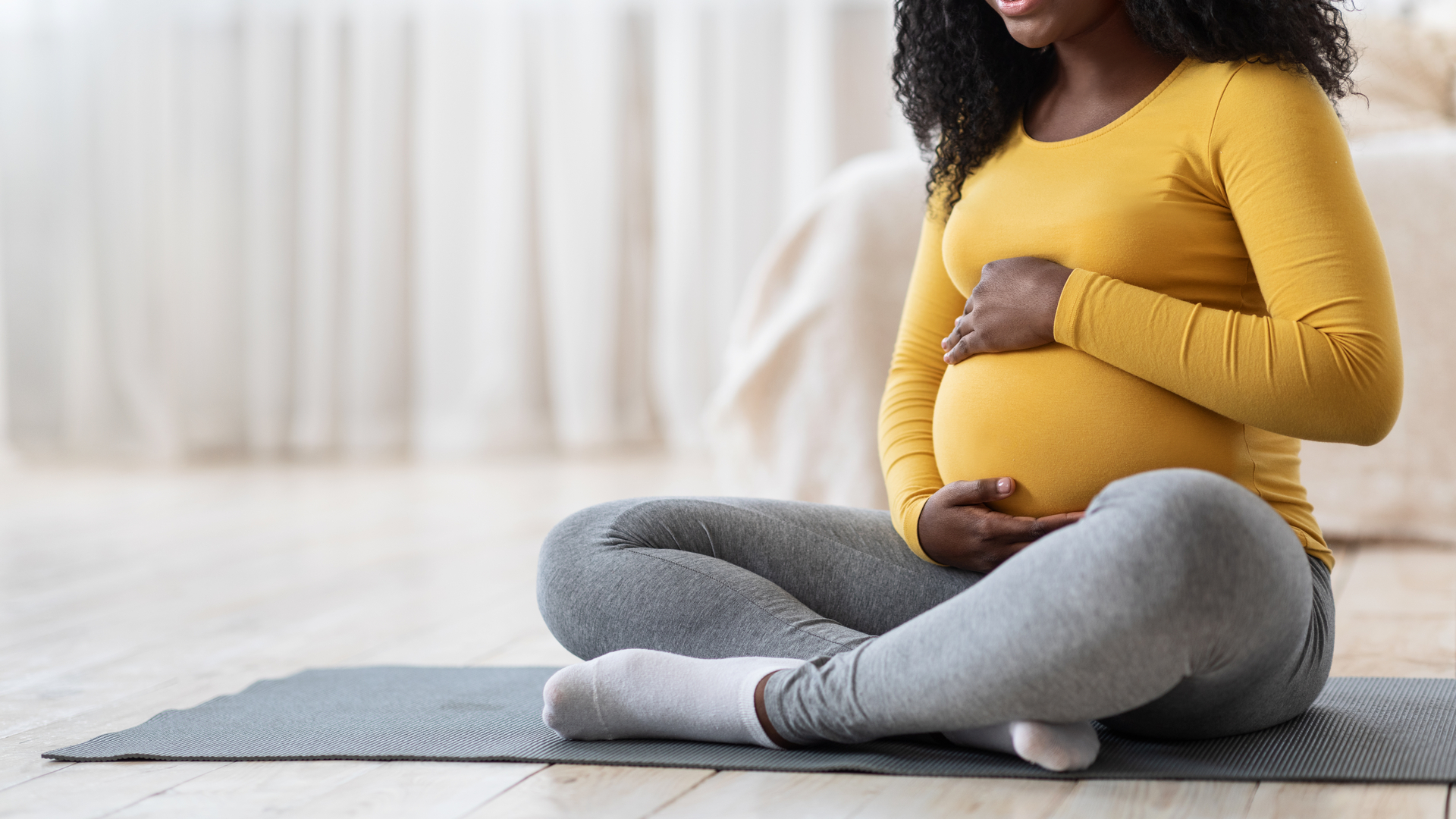 Pregnant woman sitting on floor