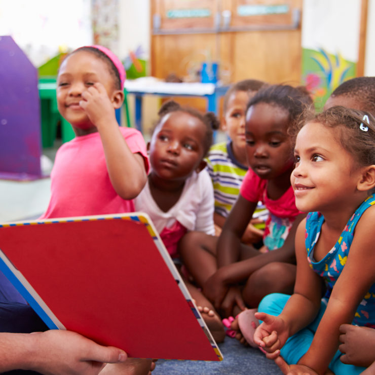 teacher reading to a class of preschool kids