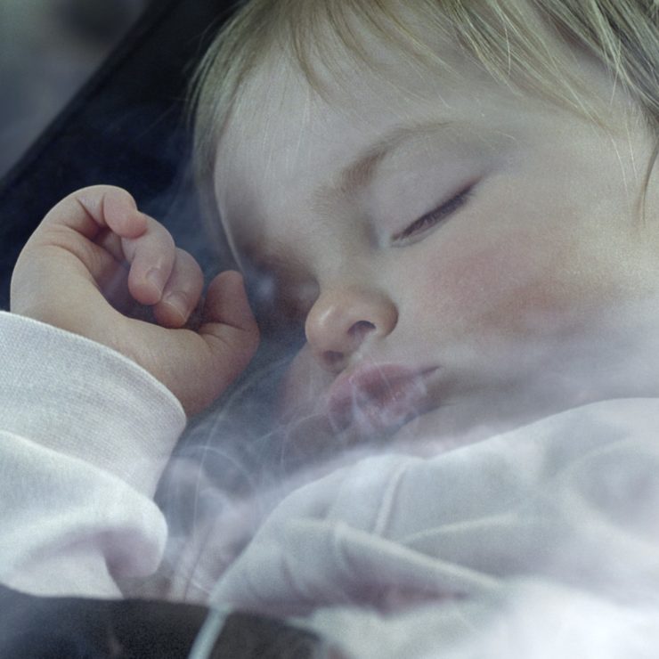 Baby asleep with smoke around it