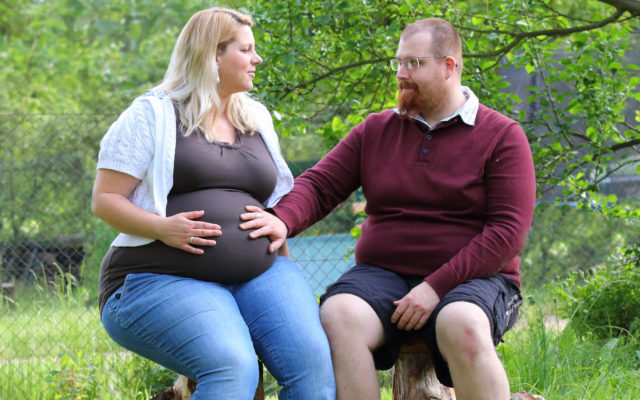 Pregnant couple in park