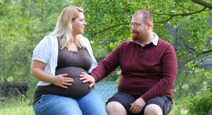 Pregnant couple in park