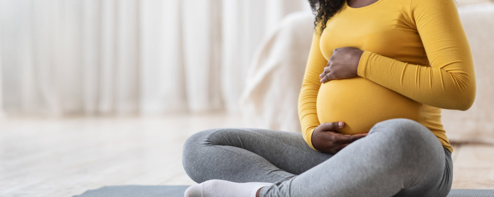 Pregnant woman sitting on floor
