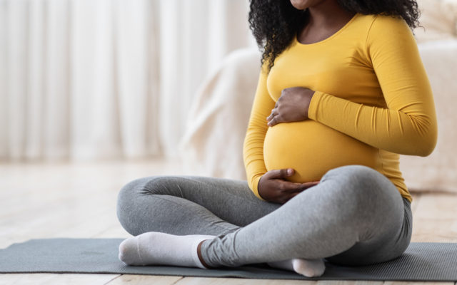 Pregnant woman sitting on floor