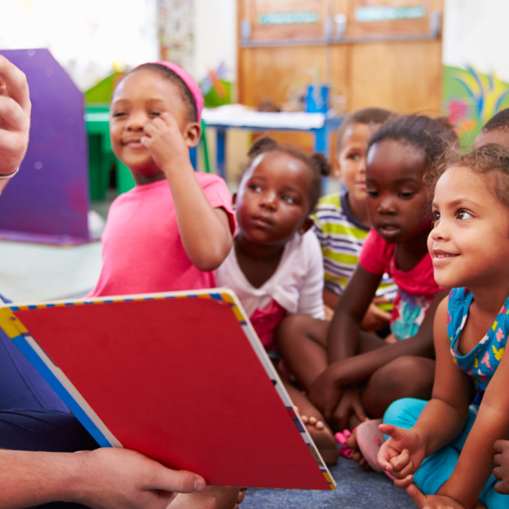 teacher reading to a class of preschool kids