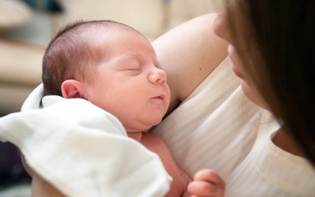 Mother cradling newborn baby