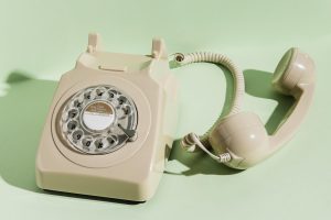 Old spin dial phone with green background