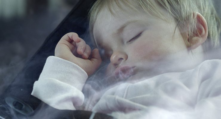 Baby asleep with smoke around it