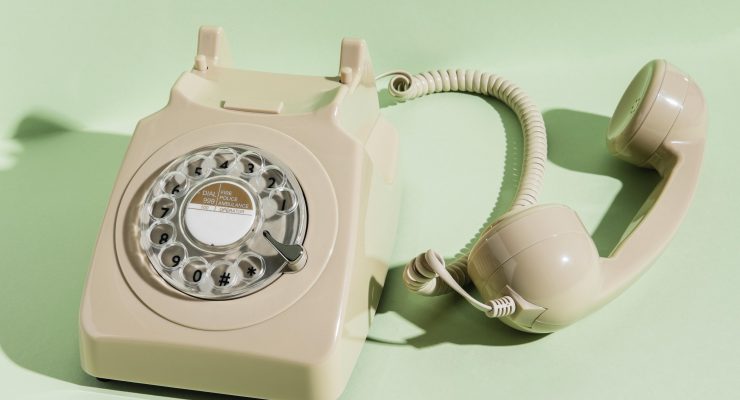 Old spin dial phone with green background