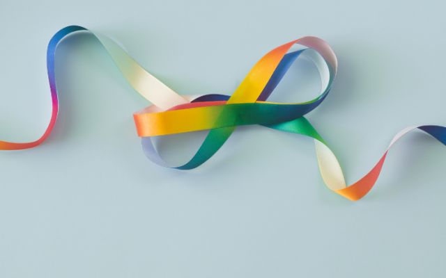 Rainbow ribbon on blue background