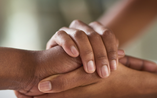 Two people holding hands