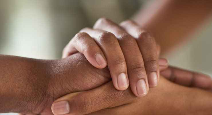 Two people holding hands