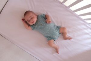Baby sleeping in a cot