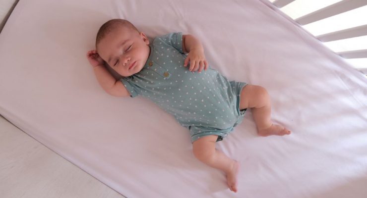 Baby sleeping in a cot