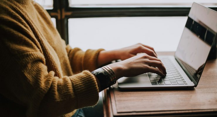 A person typing on a laptop