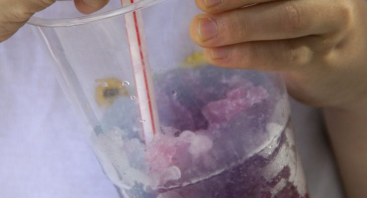 Child holding a slushie drink